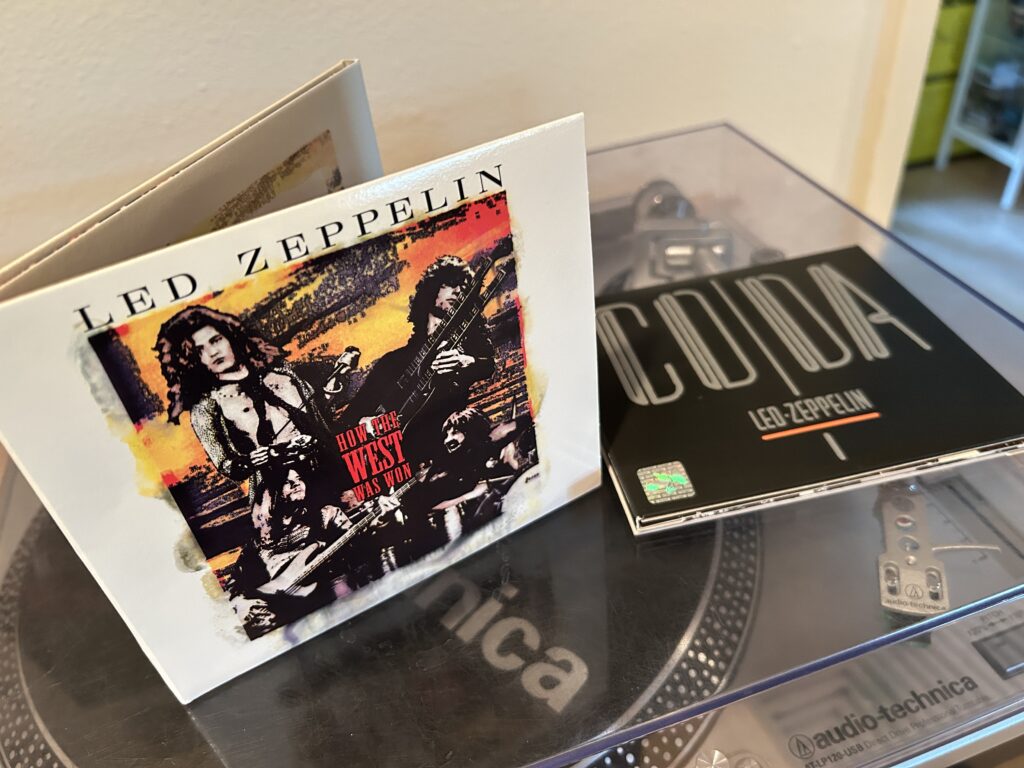 Led Zeppelin How the West Was Won CD collection and their CODA CD collection sitting on top of a record turntable on top my my awesome stereo