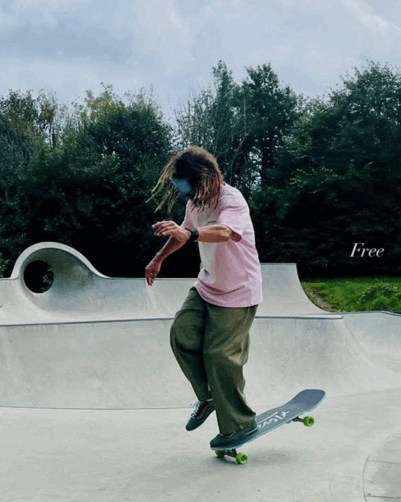 Tony Alva doing a one-footed nose wheelie on a skateboard